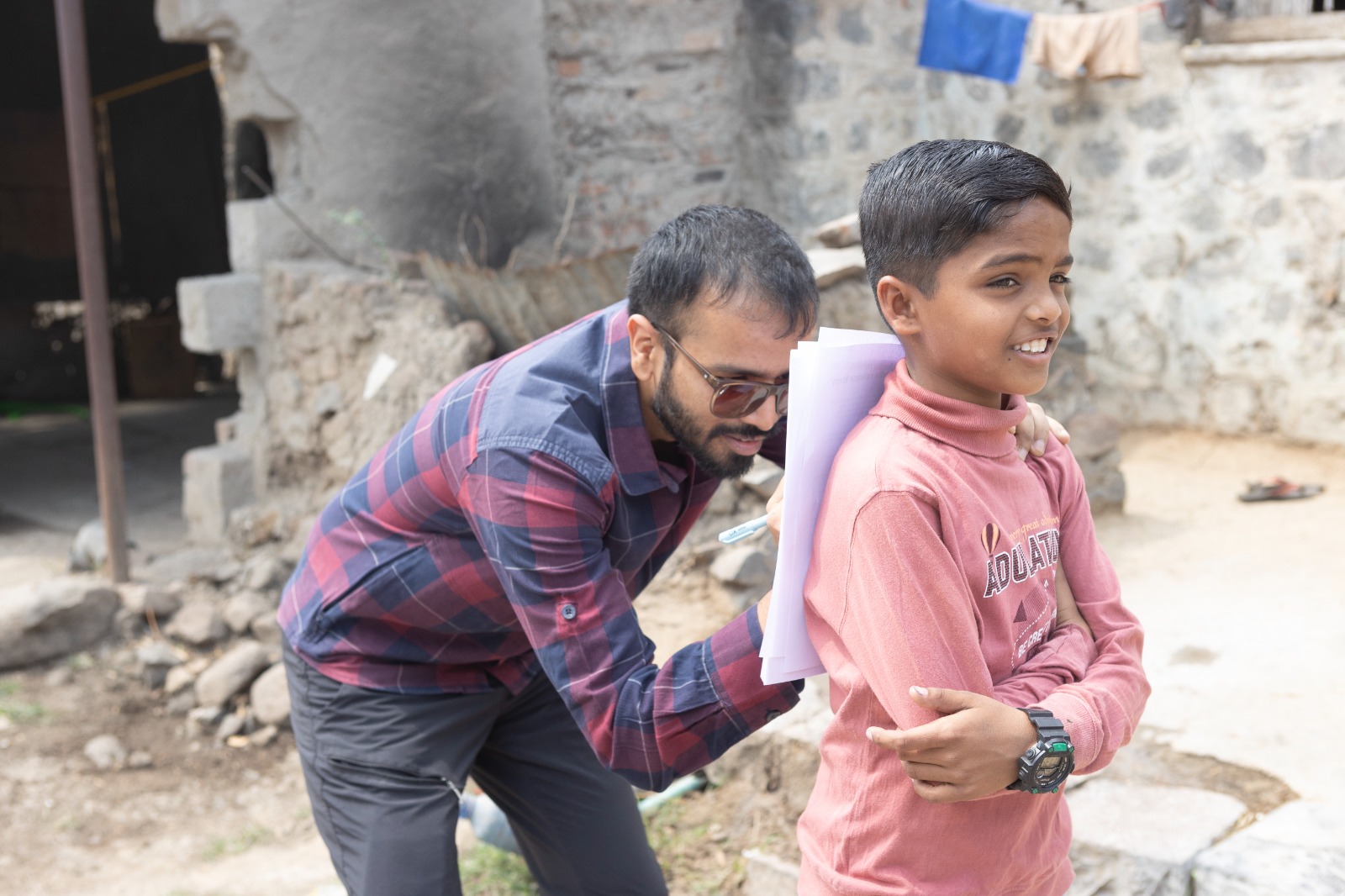 Prakhar Deep Jain working with a young contributor in the field