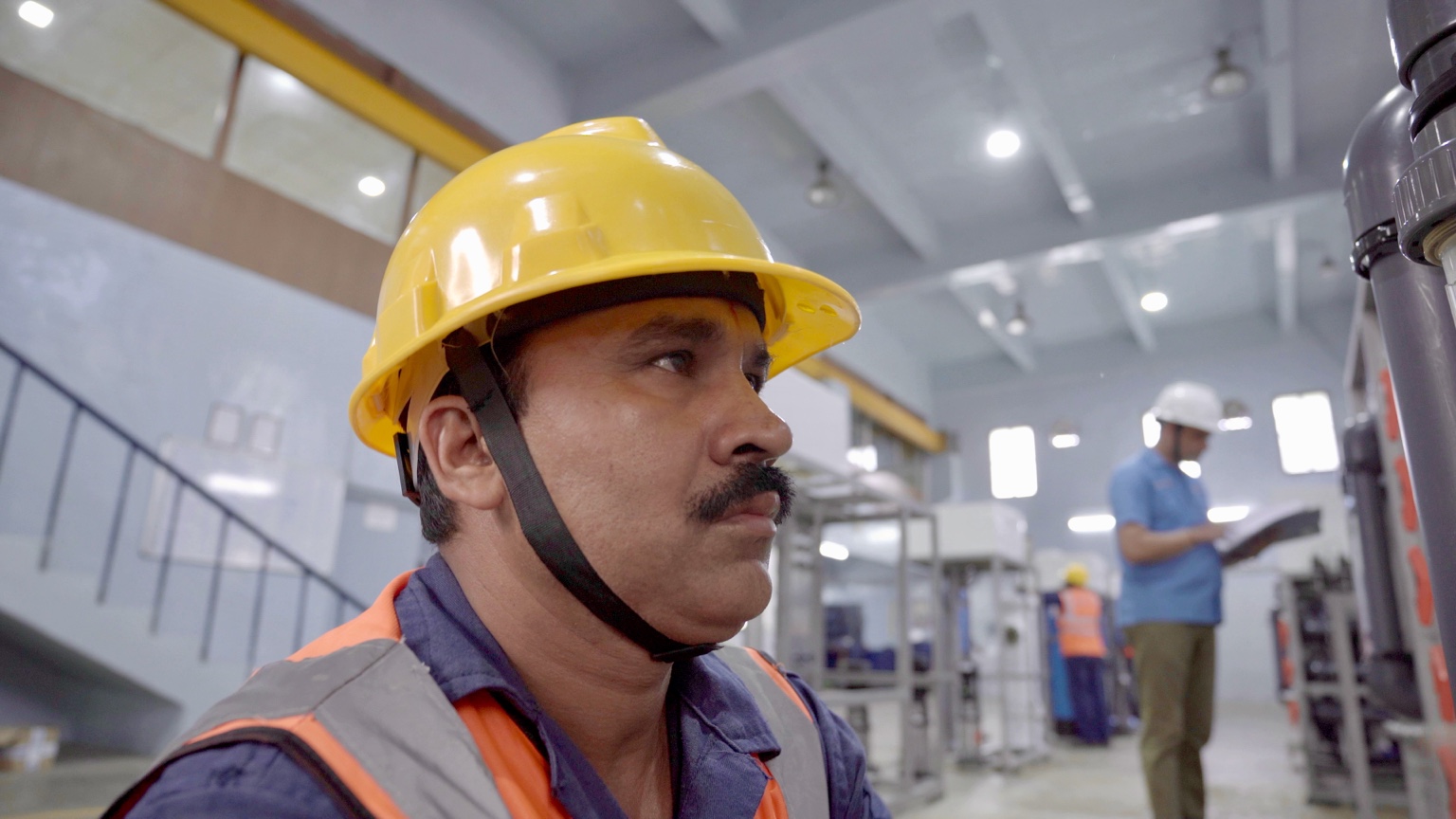 Worker operating equipment inside a GF Piping Systems facility