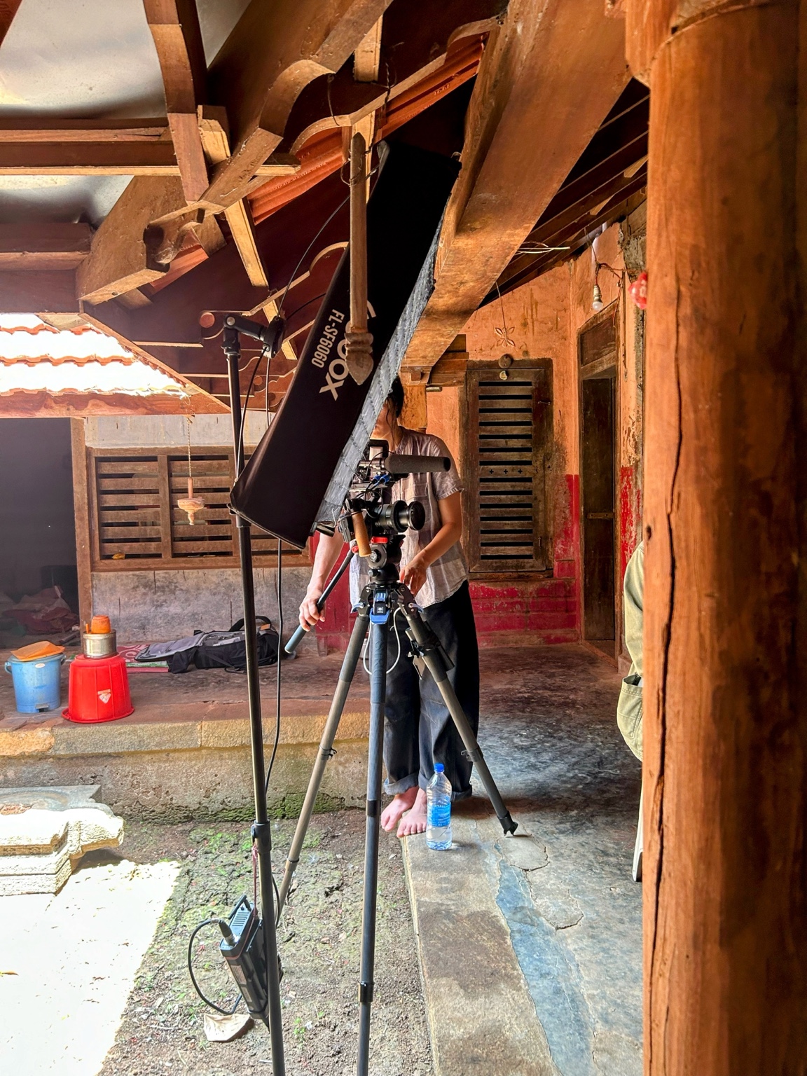 Production team filming in a traditional setting